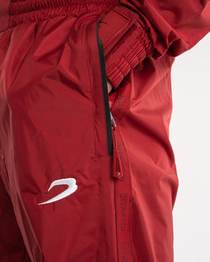 Man in a red sauna suit tracksuit with a white boxraw logo on the chest as well as adjustable wrist straps and made from polyester.