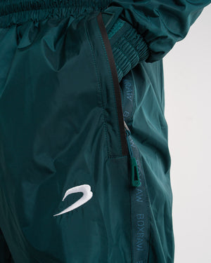 Man in a green sauna suit tracksuit with a white boxraw logo on the chest as well as adjustable wrist straps and made from polyester.