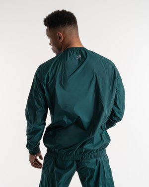 Man in a green sauna suit tracksuit with a white boxraw logo on the chest as well as adjustable wrist straps and made from polyester.