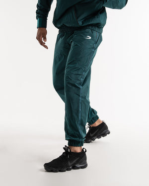 Man in a green sauna suit tracksuit with a white boxraw logo on the chest as well as adjustable wrist straps and made from polyester.