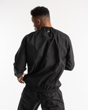 Man in a black sauna suit tracksuit with a white boxraw logo on the chest as well as adjustable wrist straps and made from polyester.