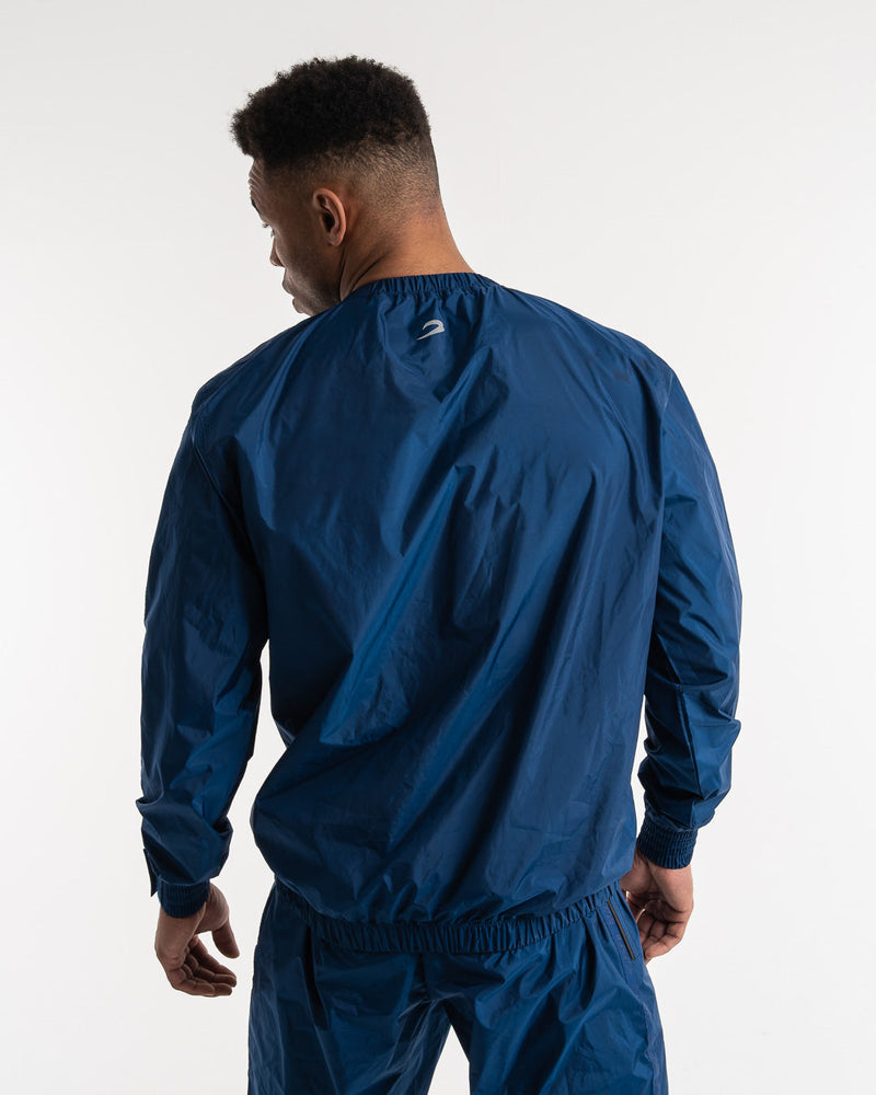 Man in a navy sauna suit tracksuit with a white boxraw logo on the chest as well as adjustable wrist straps and made from polyester.