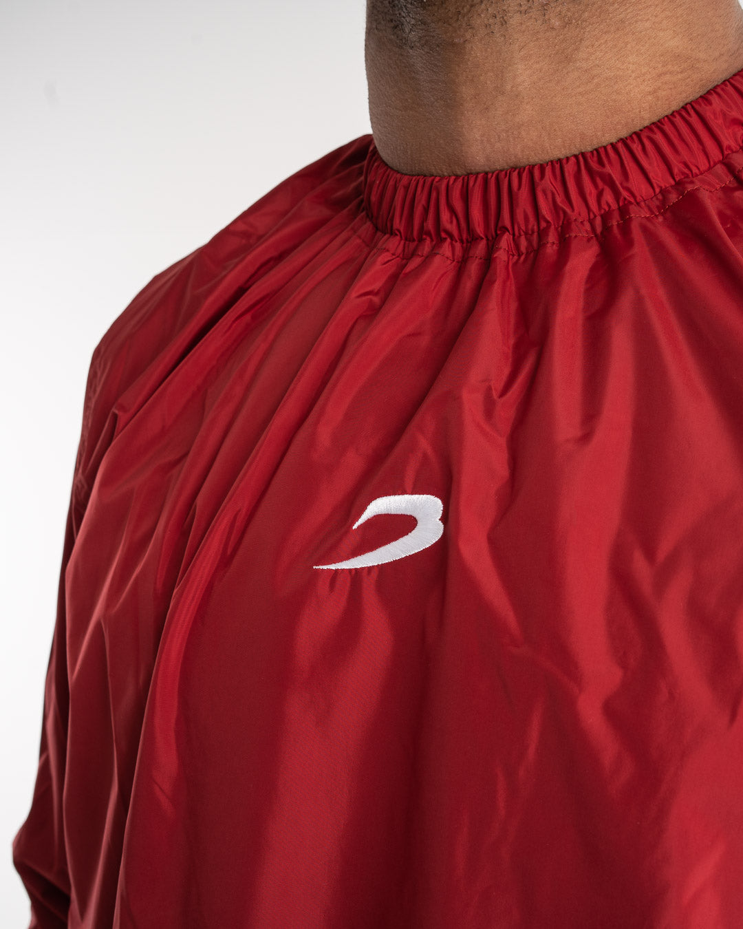 Man in a red sauna suit tracksuit with a white boxraw logo on the chest as well as adjustable wrist straps and made from polyester.